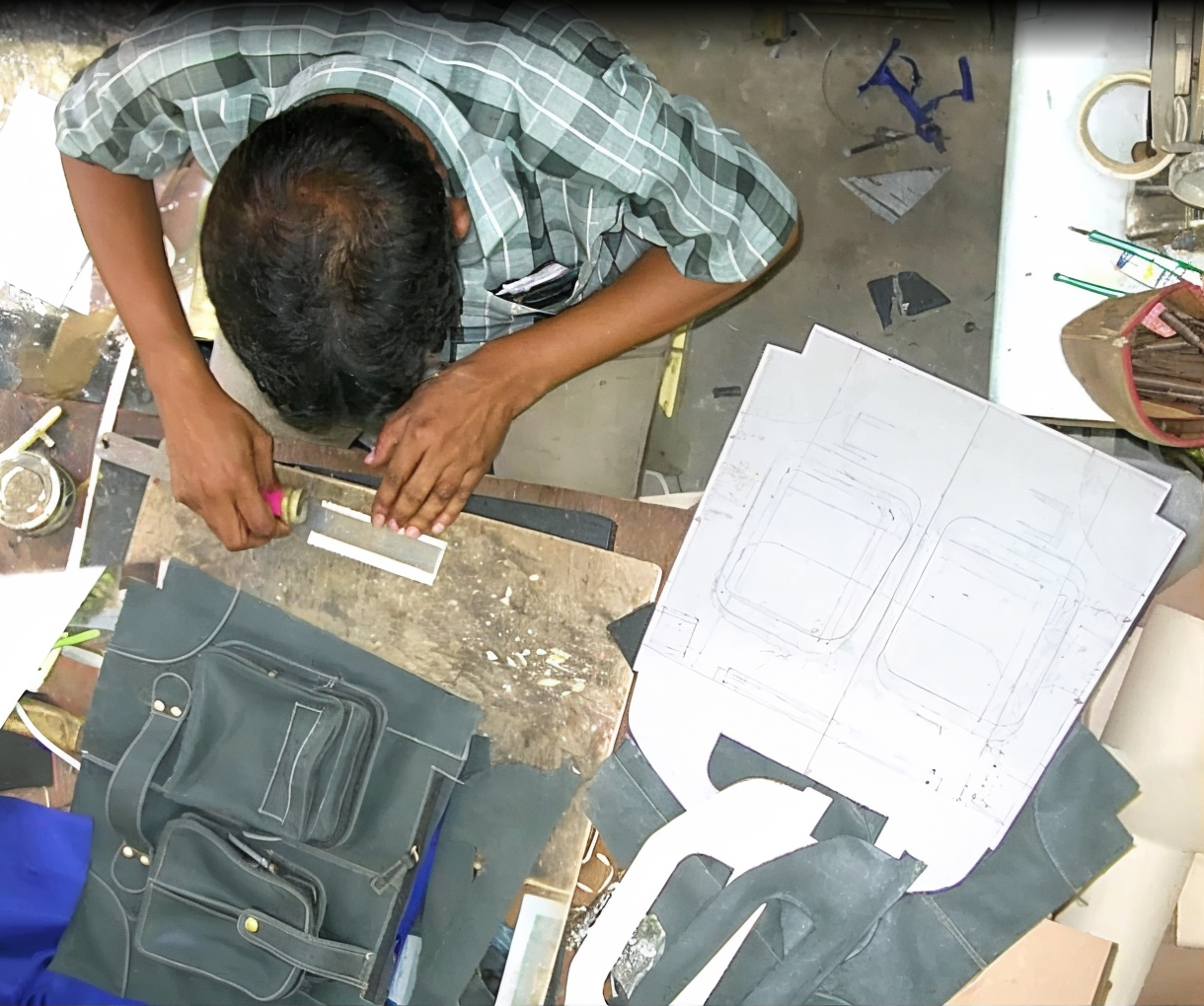 Finishing details being applied to a premium leather handbag